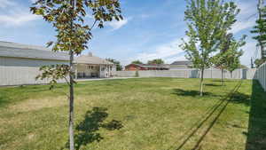 Fenced backyard with a patio