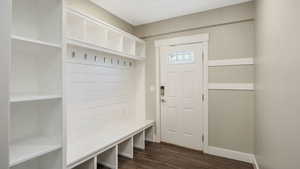 Mudroom with dark wood-style flooring and baseboards