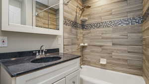 Full bathroom featuring washtub / shower combination and vanity