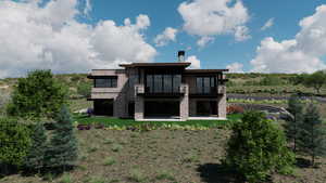 Back of house with a balcony, a patio area, stone siding, and a yard