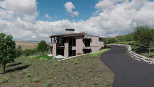 View of home's exterior featuring a chimney and a balcony