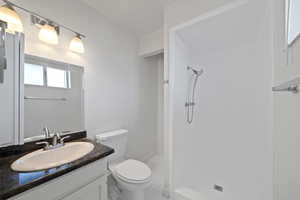 Bathroom with a stall shower and vanity