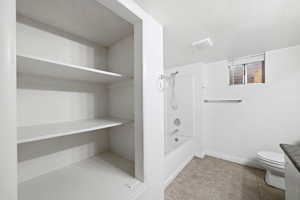 Full bathroom with  shower combination, vanity, tile patterned flooring, and a textured ceiling