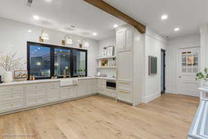 Kitchen with light wood-type flooring, light countertops, open shelves, and recessed lighting
