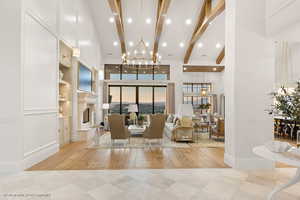 Lobby with high vaulted ceiling, recessed lighting, and beam ceiling