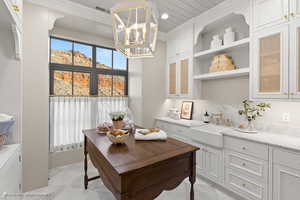 Office space featuring washer and clothes dryer, a chandelier, and recessed lighting