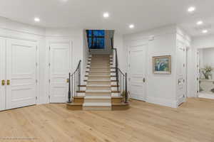 Entrance foyer featuring light wood-style flooring, stairway, and recessed lighting