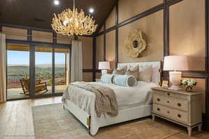 Bedroom featuring access to outside, wood finished floors, a chandelier, recessed lighting, and a mountain view