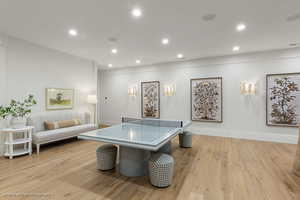 Rec room with light wood-style flooring and recessed lighting