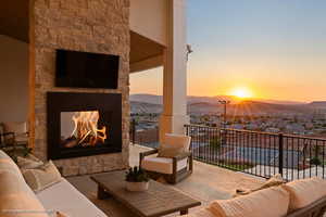 View of patio with an outdoor living space with a fireplace