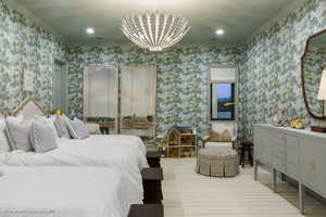 Bedroom featuring wallpapered walls, a chandelier, and recessed lighting