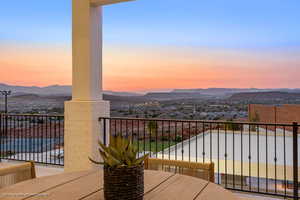 Balcony at dusk featuring a mountain view
