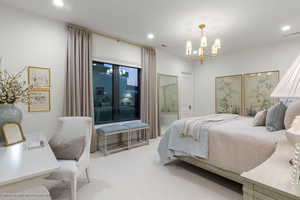 Carpeted bedroom featuring a chandelier and recessed lighting