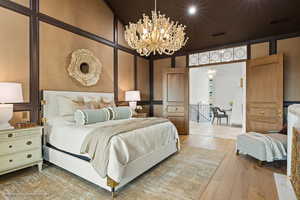 Bedroom featuring wood-type flooring and a chandelier
