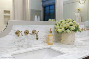 Bathroom view of tasteful backsplash and a sink