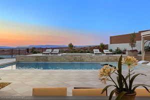 Swimming pool with a patio and a mountain view