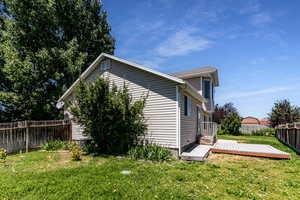 View of home's exterior featuring a fenced backyard and a wooden deck