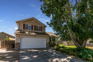 Traditional-style home with brick siding, concrete driveway, and an attached garage