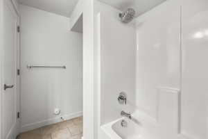 Bathroom featuring tile patterned floors and  shower combination