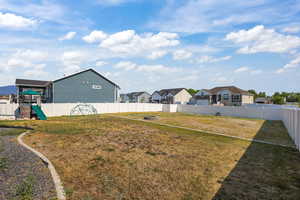 Fenced backyard with a residential view