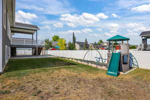 Fenced backyard with a playground and a residential view