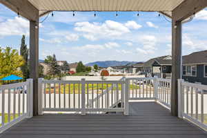 Wooden terrace featuring a residential view and a mountain view