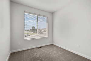 Carpeted empty room with baseboards