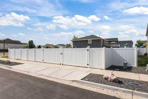 View of patio with a gate and a residential view