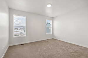 Carpeted empty room with baseboards