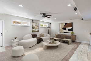 Recessed lighting and a ceiling fan illuminate this spacious room