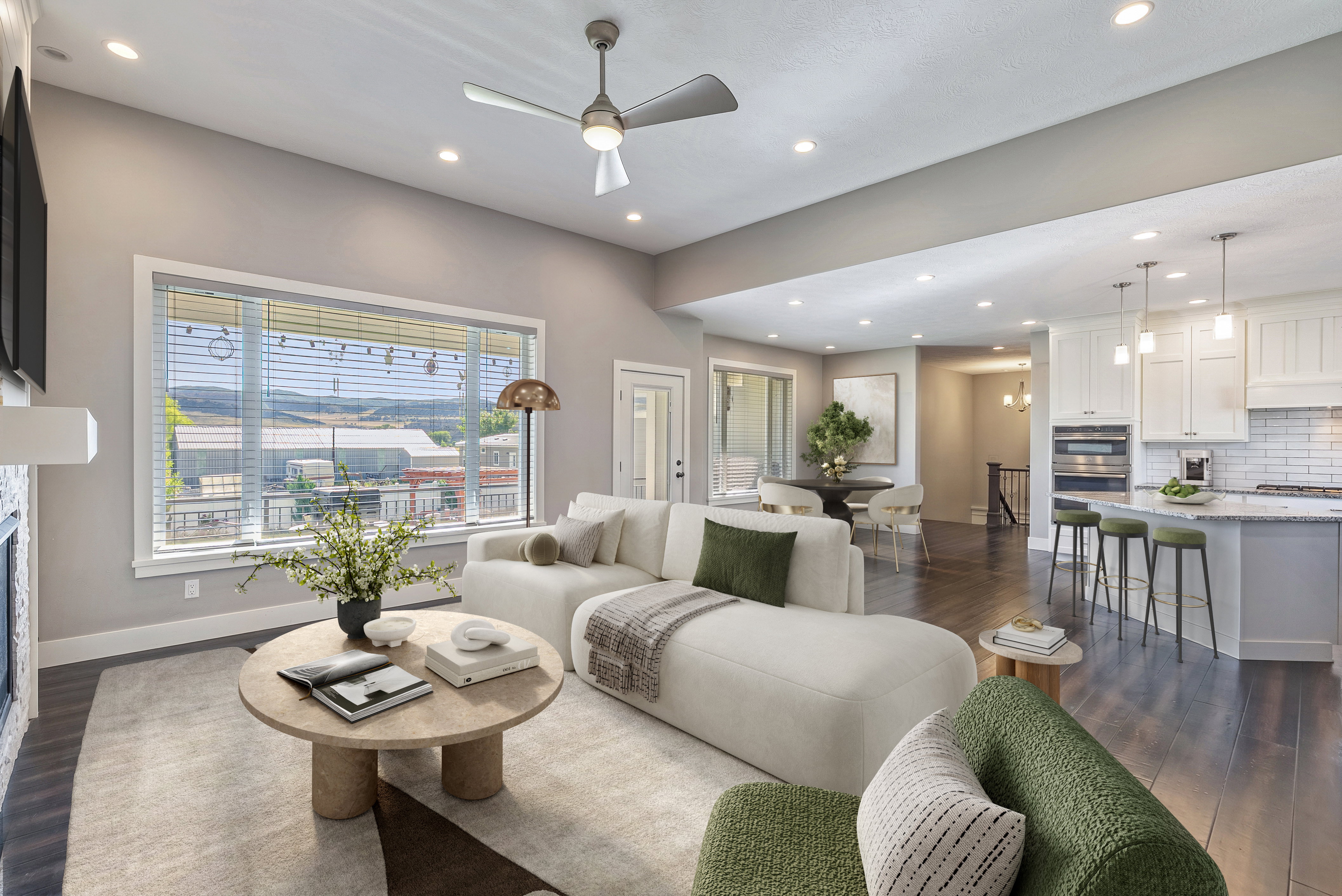 Spacious living area featuring high ceilings, recessed lighting, and wood-finish flooring