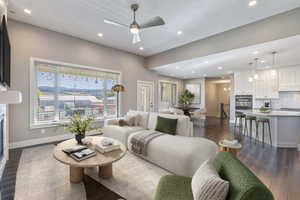 Spacious living area featuring high ceilings, recessed lighting, and wood-finish flooring