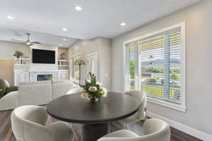 Dining area with wood-finish flooring and recessed lighting