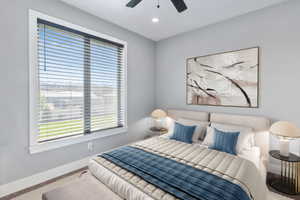 Bedroom featuring a large window with horizontal blinds, recessed lighting, and a ceiling fan