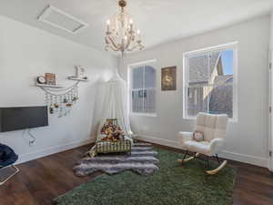 Sitting room with wood finished floors and attic access