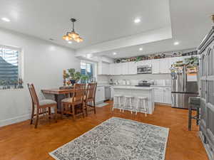 Dining room featuring recessed lighting, finished concrete floors, and a chandelier