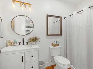 Bath with vanity and a shower with curtain