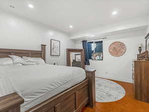 Bedroom featuring recessed lighting and wood finished floors