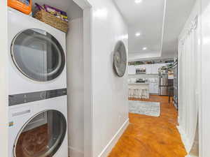 Laundry area with stacked washer / dryer and recessed lighting