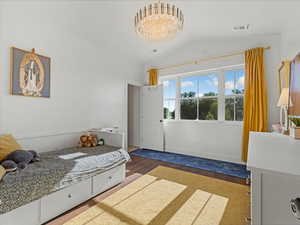 Bedroom featuring wood finished floors and vaulted ceiling