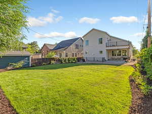 Rear view of house with a patio, a ceiling fan, a fenced backyard, and stucco siding