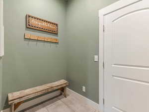 Doorway to outside with baseboards and light tile patterned flooring