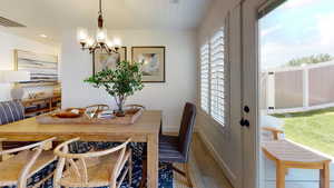 Dining space with wood finished floors, a chandelier, plenty of natural light, and recessed lighting