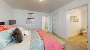 Bedroom featuring light wood-type flooring and a textured ceiling
