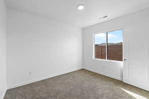 Carpeted empty room with baseboards