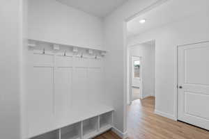 Mudroom featuring light wood-type flooring and recessed lighting