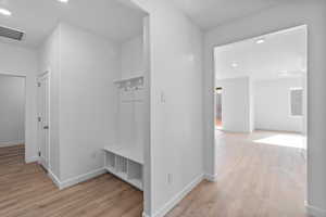 Mudroom with light wood-type flooring and recessed lighting