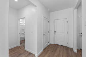 Corridor featuring wood finished floors and baseboards