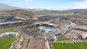 Aerial view of property's location featuring a pool area and a mountainous background