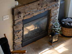 Detailed view of a stone fireplace and wood finished floors